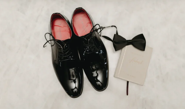 Groom accessories including formal shoes and bow tie for wedding styling consultation