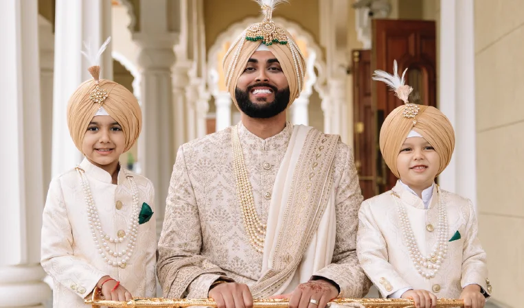 Groom with family wearing coordinated sherwani and turban for wedding day styling