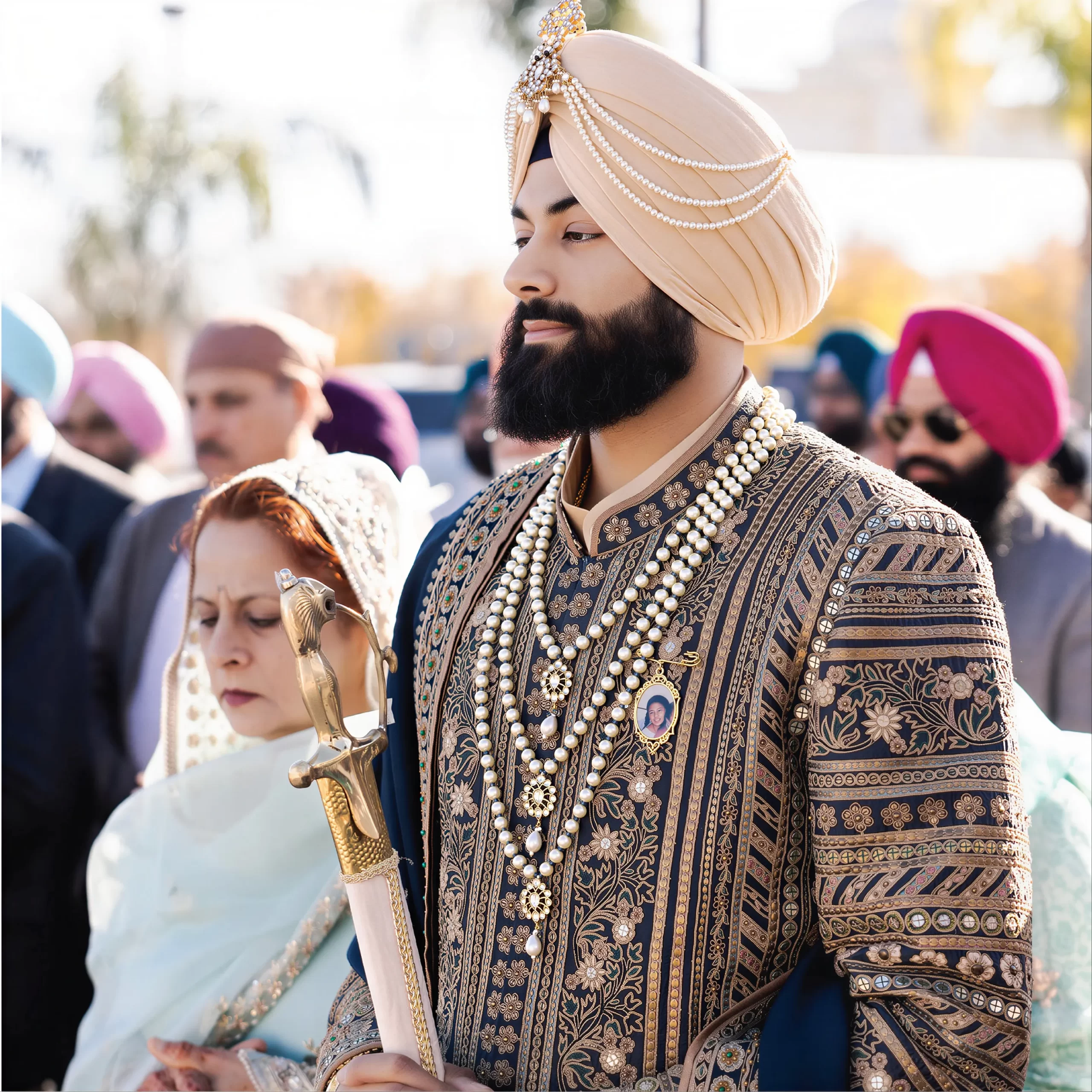 Sikh groom wearing embroidered sherwani and layered jewellery styled for wedding groom styling